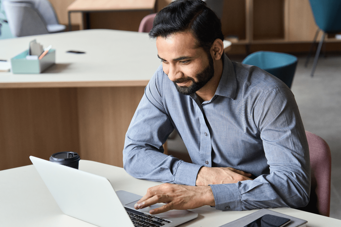 Person at a desk working on a laptop